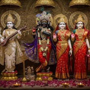 A magnificent temple interior with three ornately decorated deities side by side - Lord Krishna in the center wearing a peacock feather crown, golden pitambara, and precious gem necklaces, flanked by Goddess Lakshmi on the right adorned in a red silk saree with gold border, traditional temple jewelry, and lotus flowers, and Goddess Saraswati on the left in pure white silk with veena and crystal accessories. The deities stand on golden lotus pedestals amid scattered flower petals. Multiple brass deepa lamps cast a warm ethereal glow, creating dramatic shadows. The background features an intricately carved wall with Madhubani-style patterns in gold and deep maroon. Floating translucent mandalas with sacred geometric patterns hover behind each deity. The scene is captured in a modern digital art style while maintaining traditional Indian artistic elements, with rich jewel tones of royal blue, deep red, and burnished gold. Visible details include kundan work, temple jewelry designs, precious stones, and flowing fabric textures. The lighting emphasizes the metallic gleam of the ornaments and creates a divine, otherworldly atmosphere.