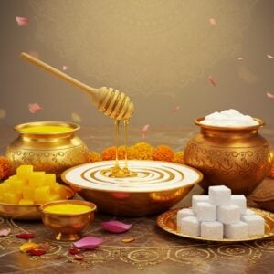 A luxurious, ethereal composition featuring five sacred ingredients of Panchamrita arranged in traditional copper and golden vessels against a soft, glowing backdrop. The central focus shows honey dripping in golden streams into fresh milk, creating a mesmerizing swirl pattern. Around it, vibrant yellow ghee in an ornate deepam, crystalline sugar cubes on a silver plate reflecting light, and fresh curds in a traditional clay pot adorned with mandala patterns. Each ingredient emits a subtle divine aura. Floating lotus petals and delicate marigold flowers frame the scene. The background features an intricately detailed Madhubani-style mandala in shades of saffron and deep blue. Gentle rays of golden light illuminate the scene from above, creating a mystical atmosphere. Small wisps of sacred smoke from lit camphor add depth. The overall composition follows traditional Indian art principles with modern digital rendering, emphasizing the divine nature of these ingredients. The scene is set on a polished marble surface with subtle reflections, decorated with rangoli patterns in gold dust.