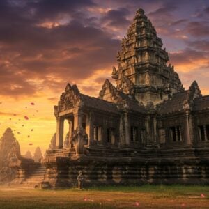 A majestic ancient Khmer temple complex perched atop an extinct volcano, illuminated by golden sunrise light. The temple's sandstone architecture features intricate carvings of Hindu deities and mythological scenes, with prominent naga serpents flanking the grand staircase. The main prang tower rises dramatically against a mystical sky filled with swirling clouds in deep purples and oranges. Foreground shows detailed stone elephants and traditional Khmer guardian statues. The scene captures both the temple's perfect solar alignment during sunrise and its architectural grandeur with precise geometry. Decorative lintels with detailed Vishnu carvings visible on doorways. Scene enhanced with soft floating lotus petals, subtle lens flares, and ethereal mist around the base. Art style combines photorealistic architectural details with mystical digital painting techniques. Lighting emphasizes the golden hour glow on the sandstone, creating dramatic shadows and highlighting the intricate bas-reliefs. The composition includes leading lines from the ceremonial walkway to draw viewers into the scene.