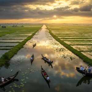 A serene aerial perspective of the vast Kole wetlands during golden hour, with traditional Kerala wooden boats gliding through mirror-like waters. In the foreground, a group of Indian photographers with modern cameras capturing images of migratory birds in flight. The wetlands stretch endlessly into the horizon, dotted with emerald green paddy fields in geometric patterns. Vibrant pink lotus flowers bloom across the water surface, while white egrets and painted storks wade through the shallows. Traditional fishing nets cast intricate shadows on the water. The sky features dramatic monsoon clouds in shades of gold and purple, with sunbeams breaking through. Modern eco-friendly viewing platforms blend seamlessly with the landscape. The scene combines photorealistic detail with ethereal lighting, rendered in a style mixing traditional Indian art patterns with contemporary digital art techniques. Rich colors of deep blues, emerald greens, and golden yellows dominate, with careful attention to reflections in the water. Cinematic composition, tilt-shift effect, ultra-detailed, architectural visualization, 8k quality.