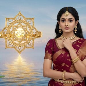 A majestic depiction of the Sudarshana Chakra, intricately designed as a golden, jewel-encrusted accessory, glowing with divine energy. The background features a serene, ethereal landscape with soft, pastel hues of blue and gold. The chakra floats above a calm, reflective water surface, surrounded by delicate lotus flowers and subtle glowing mandalas. In the foreground, a young Indian woman adorned with Sudarshana Chakra-inspired jewelry stands gracefully. Her attire is a blend of traditional and modern, featuring a deep maroon saree with gold accents. She exudes an aura of tranquility and spiritual power. The scene is illuminated with soft, radiant light, emphasizing the divine nature of the accessories. The art style is a fusion of traditional Indian art and modern digital aesthetics, creating a captivating, surreal image that embodies the spiritual significance of the Sudarshana Chakra.