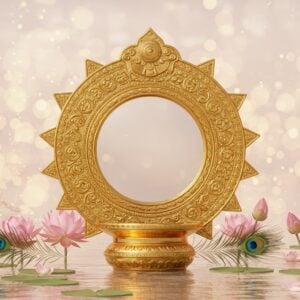 An intricately designed Aranmula Kannadi (traditional metal mirror) set against a backdrop of a serene, ethereal landscape. The mirror is crafted with exquisite detail, showcasing its polished, reflective surface surrounded by ornate gold carvings inspired by traditional Indian motifs. Around it, lush lotus flowers bloom, and delicate peacock feathers are gently scattered, symbolizing elegance and purity. The scene is bathed in soft, glowing lights of pale pink and warm gold, creating an aura of mystique and allure. In the background, subtle hints of Madhubani and Pattachitra art patterns intertwine with modern digital aesthetics, adding depth and richness to the visual composition. The overall tone is tranquil and harmonious, inviting the viewer to explore the cultural significance of this unique artifact.