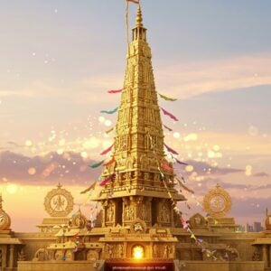 A majestic Dwajasthambam (flagstaff) stands tall in the center, crafted with intricate carvings and adorned with vibrant, colorful flags fluttering in the breeze. The scene captures a fusion of traditional Indian temple architecture and a modern digital art aesthetic. Surrounding the flagstaff are symbols from various cultures, subtly integrated into the design, including lotus flowers, mandalas, and other spiritual motifs. The background features a soft pastel sky with glowing lights, giving an ethereal and serene atmosphere. The scene is bathed in warm golden hues, highlighting the rich details and emphasizing the cultural significance of the Dwajasthambam. This visually captivating image invites viewers to delve into the depths of its meaning and significance across different cultures.