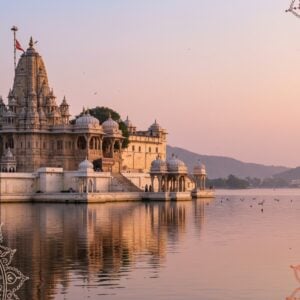 A mesmerizing scene of Udaipur's sacred spaces, featuring an intricately detailed temple with ornate carvings and towering spires, set against the backdrop of a serene, reflective lake. The architecture is highlighted with deep gold and maroon hues, capturing the essence of Rajasthani grandeur. In the foreground, traditional Indian motifs like lotus flowers and mandalas are subtly integrated into the design. The sky is a soft pastel pink and blue, with a gentle, warm glow illuminating the temple. The overall composition exudes a sense of spirituality and cultural richness, merging traditional art styles with modern digital aesthetics to captivate the viewer's attention.